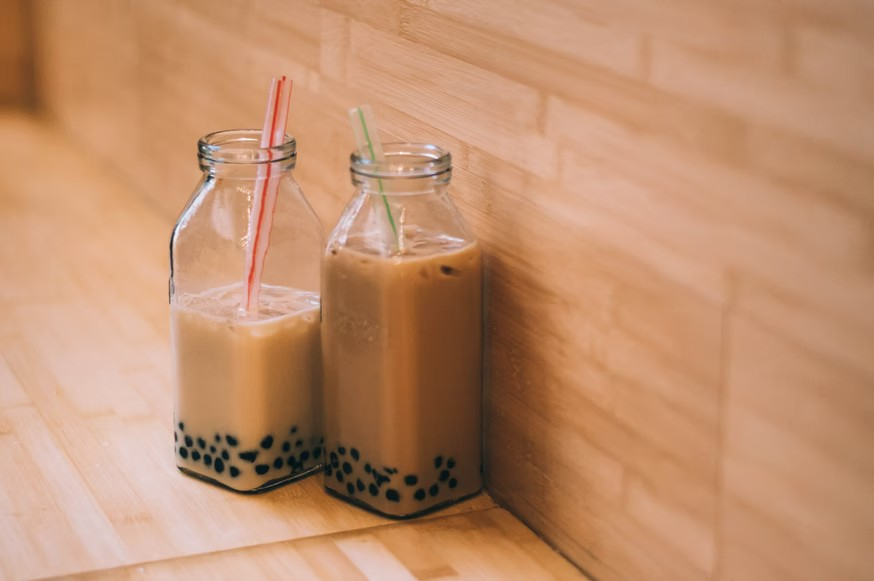 Boba tea in glass bottles with plastic straws