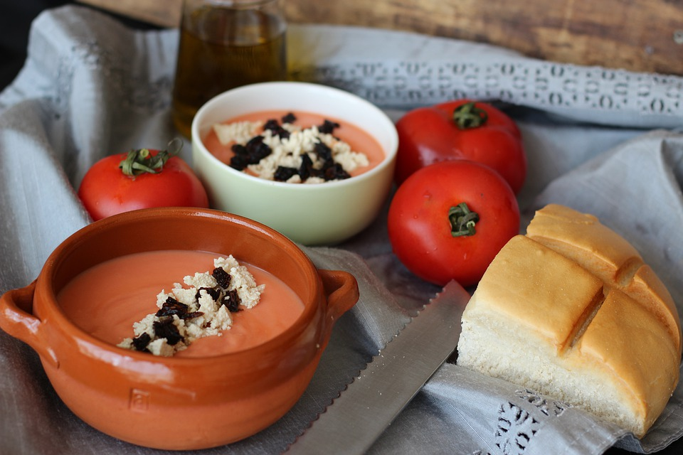 Two Bowls of Salmorejo, A Piece of Bread, Three Tomatoes, and a Knife