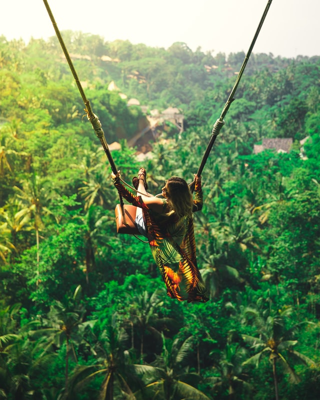 A woman enjoying on a swing during her trip to Bali