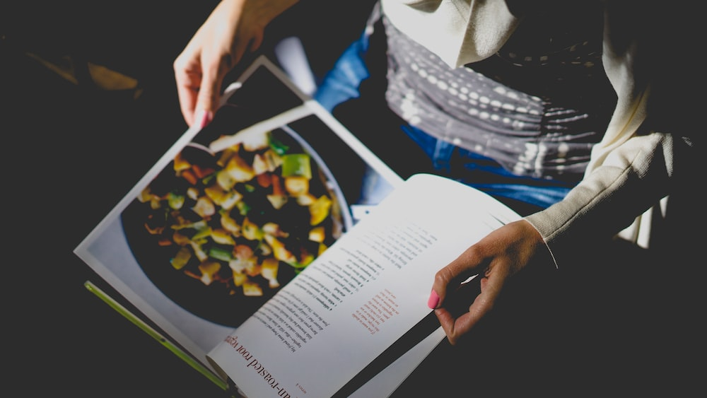 A woman reading a cookbook