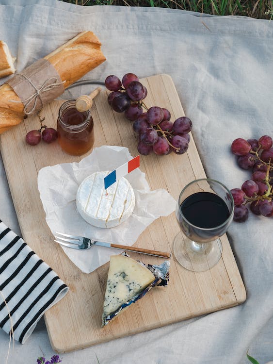 cheese and wine on a board