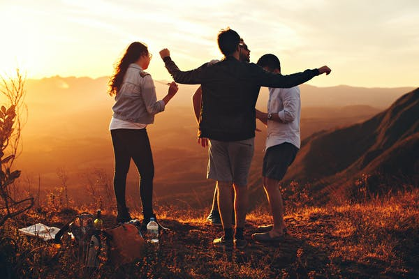 people enjoying themselves on top of a mountain