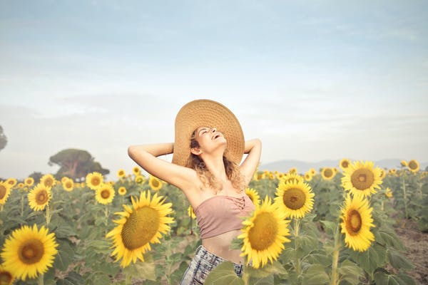 a woman in a sunflower field