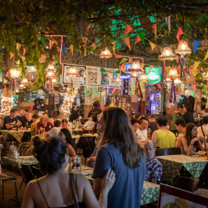 crowds of people gathered to enjoy street food at open-air eateries and the nightlife Irina Bukatik